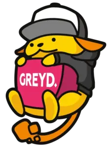 Greyd Wapuu in a black hoodie with a grey and white cap, holding a purple block with "Greyd" written on it. The end of the tail below the Wapuu body has the same shape as the Greyd logo.